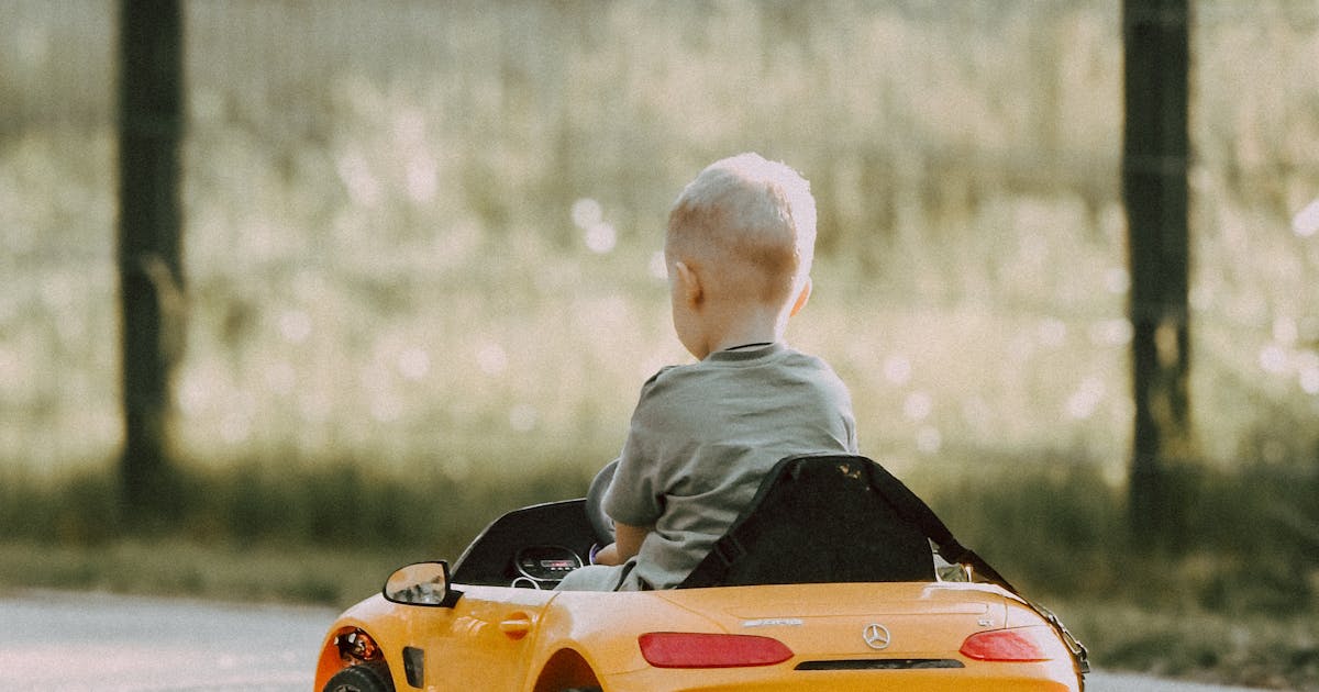 Kids ride on electric car India - child driving toy car outdoor sunny day
