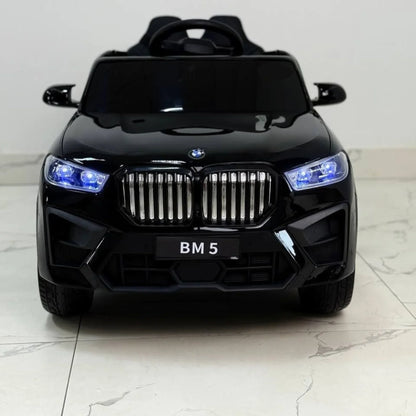 Black toy car with BMW logo on a light gray background