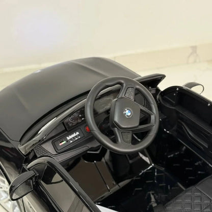 Steering wheel with BMW logo in a toy car interior