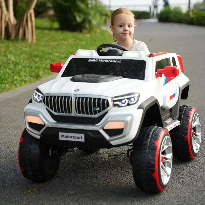 Child playing with a toy BMW car on a road
