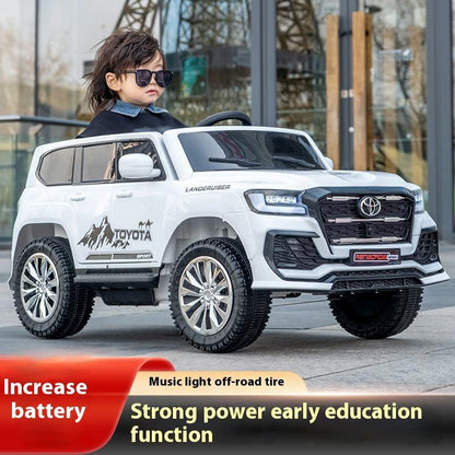 Child playing with a toy Toyota SUV in an outdoor setting
