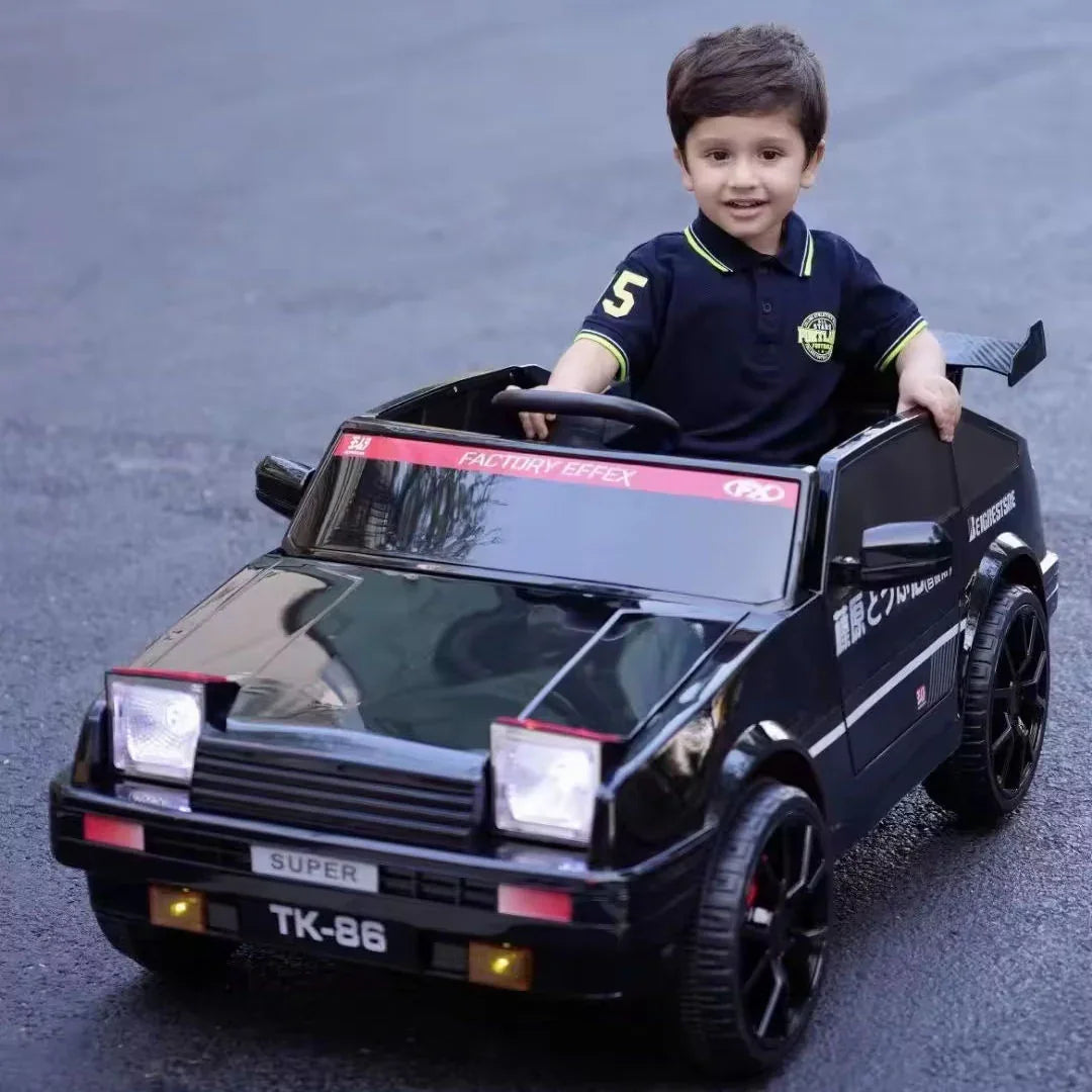 Child sitting in a toy car on a road