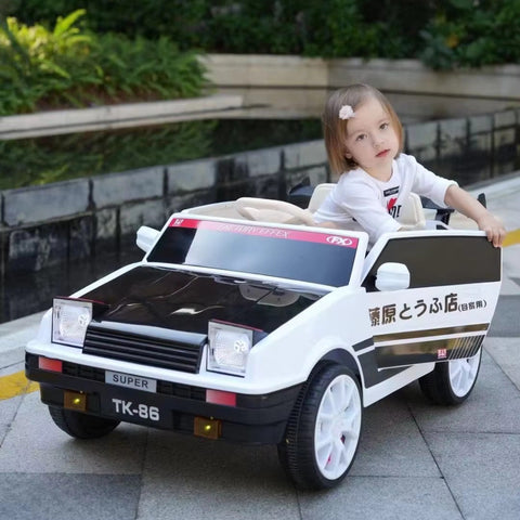 Child playing with a toy car on a sidewalk