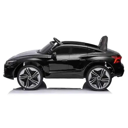 Black toy car with silver rims on a white background