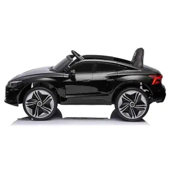 Black toy car with silver rims on a white background