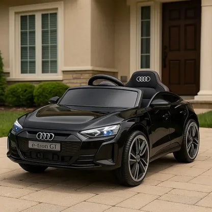 Black Audi toy car on a driveway in front of a house
