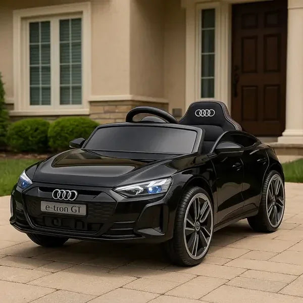 Black Audi toy car on a driveway in front of a house