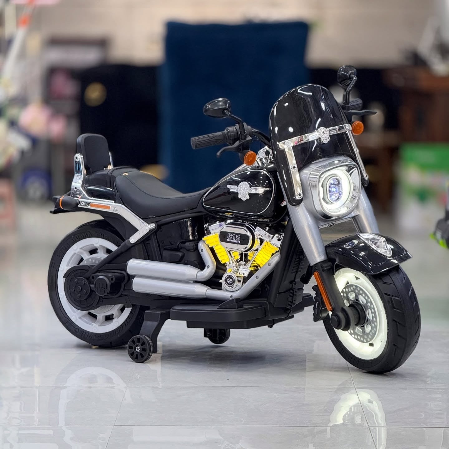 Harley Davidson motorcycle on a reflective surface with a blurred indoor background