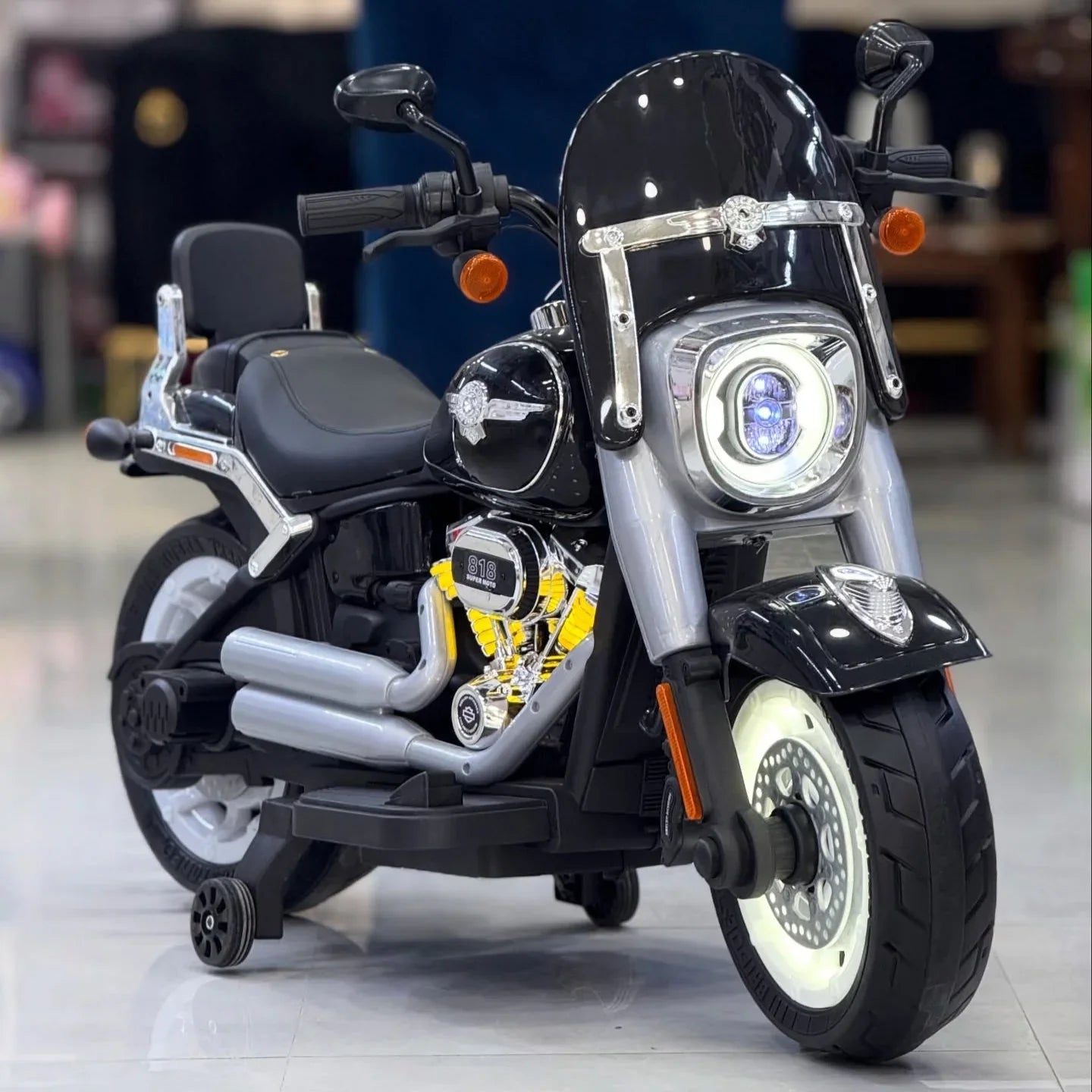 Harley Davidson Black toy motorcycle with detailed design on a reflective surface